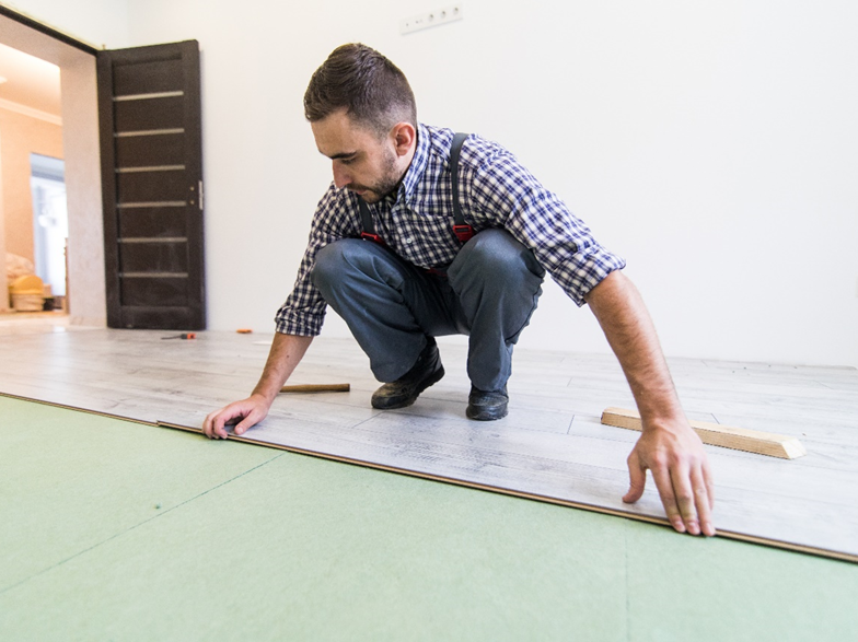 A Professional Who is Installing Laminate Flooring